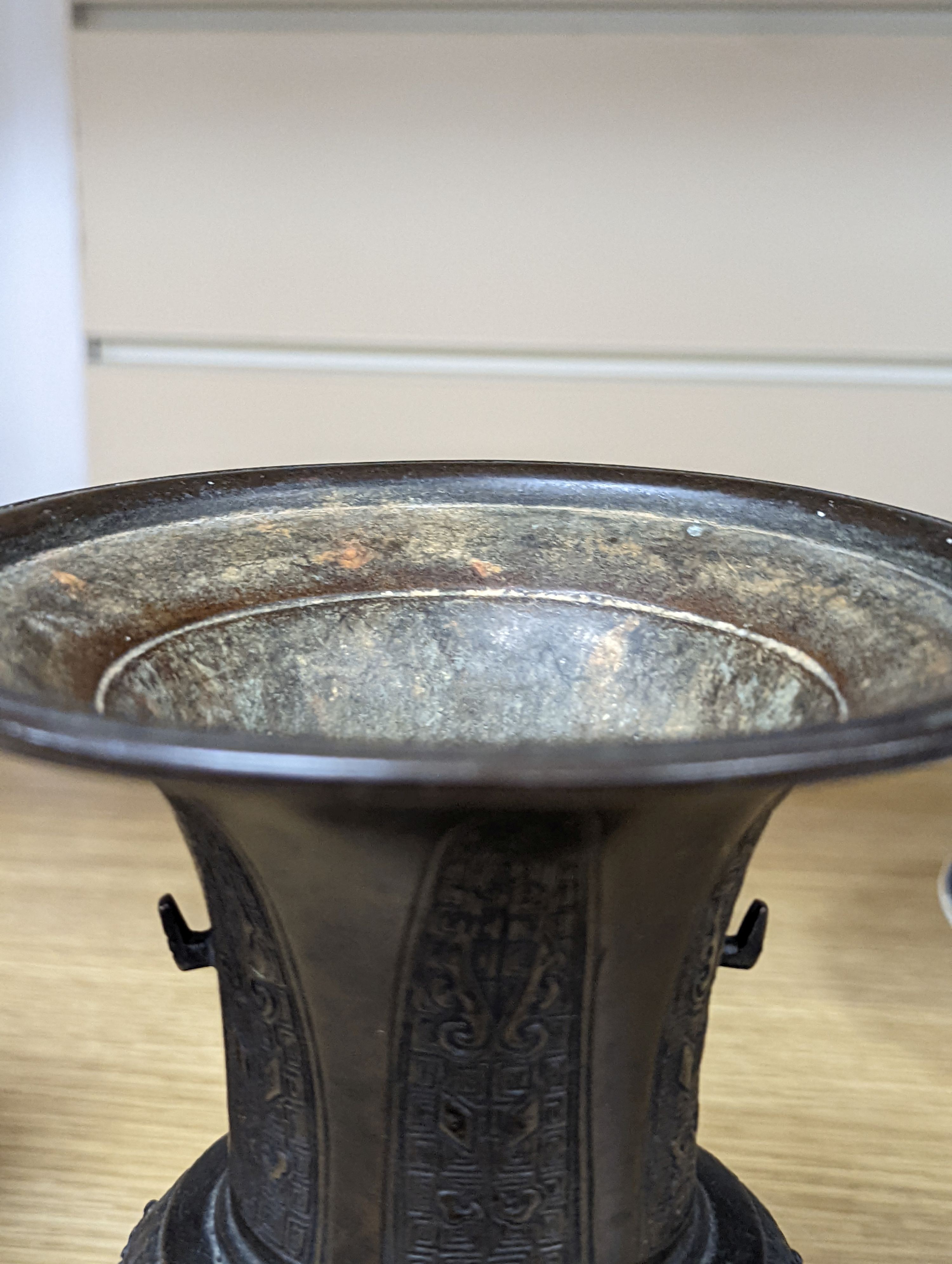 A pair of Japanese Meiji period bronze ‘dragon’ bottle vases and another, 21cm